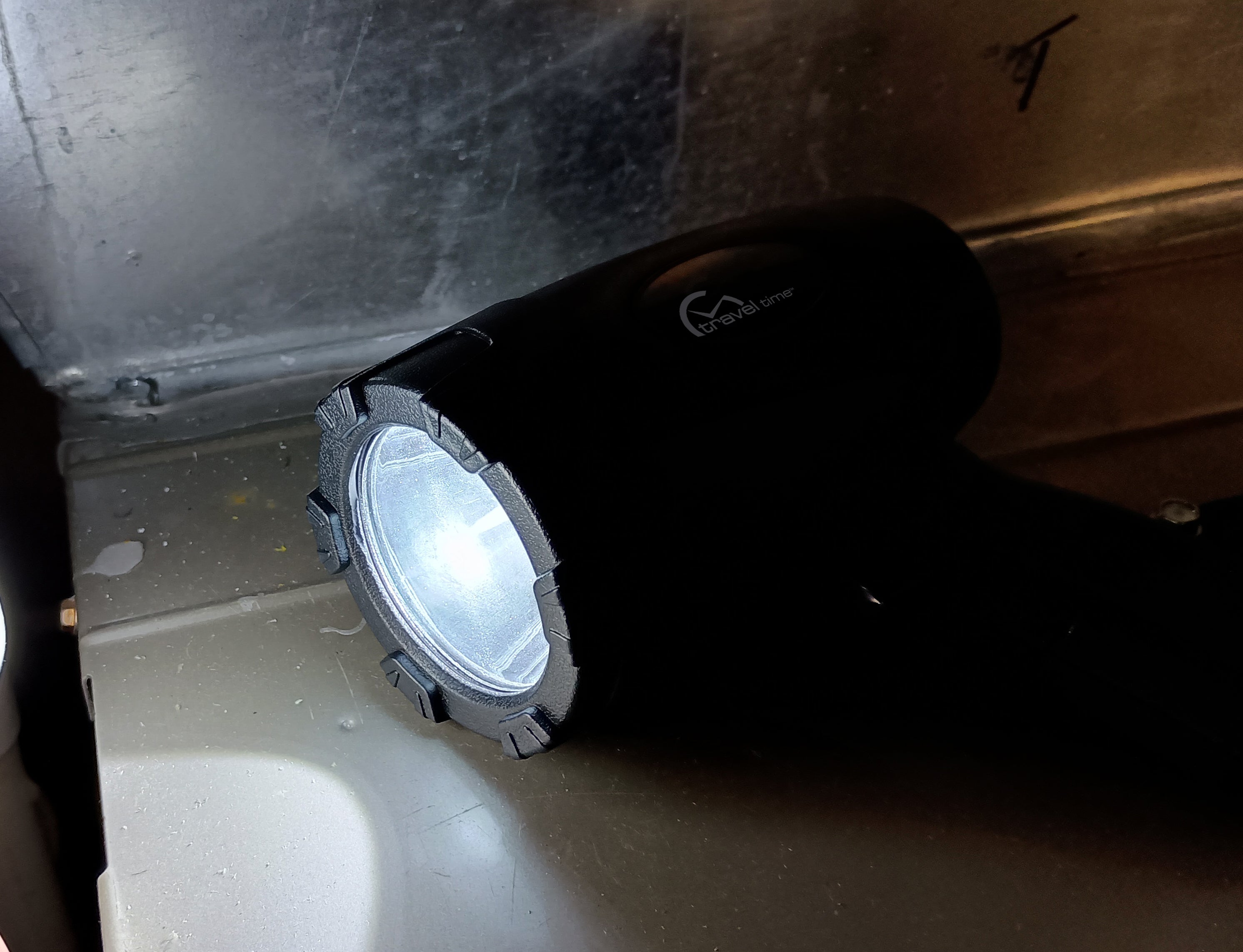 12 Volt LED Rechargeable Spotlight illuminating a dark mechanical area