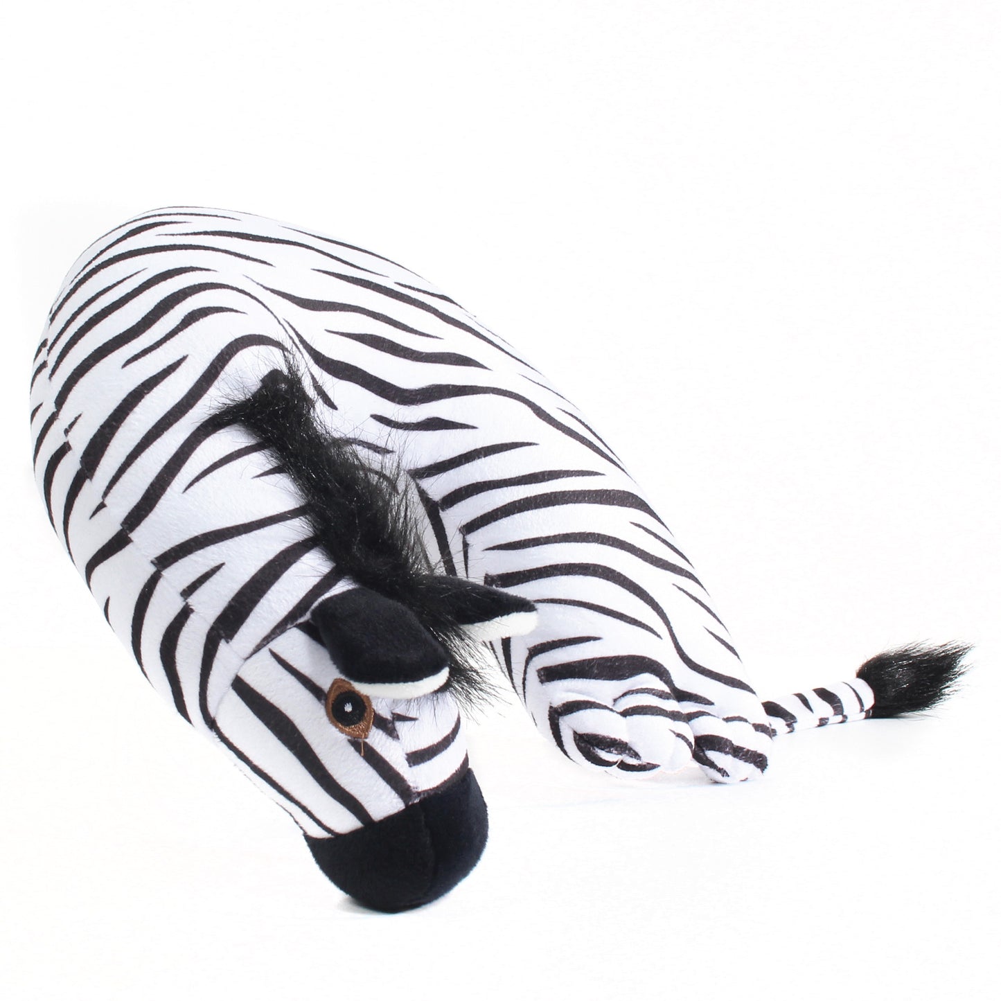 Side view of the Zebra Kids' Junior Travel Pillow. This travel neck pillow features a soft, black and white striped body with embroidered facial features, ears, furry hair, and a tail.
