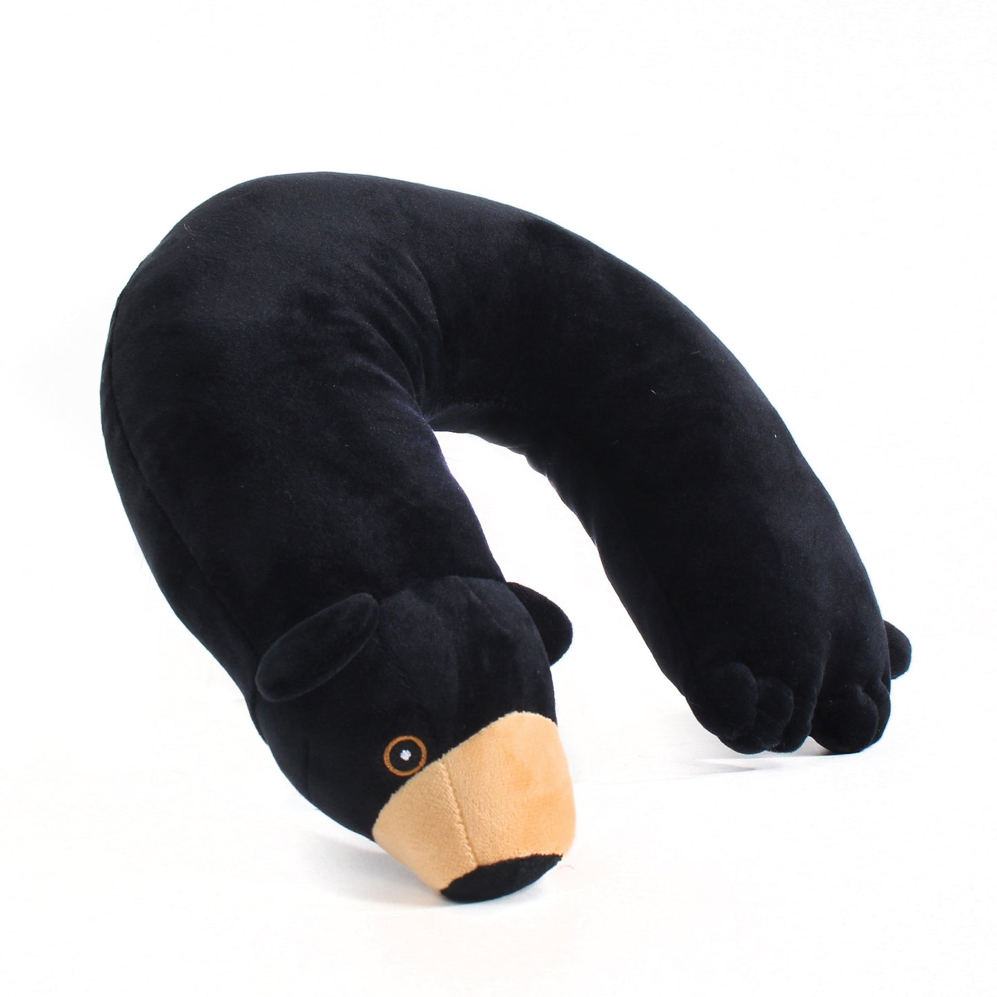 Side view of the Bear Kids' Junior Travel Pillow. This travel neck pillow features a soft, black body with embroidered facial features, ears, a brown snout, and a tail.