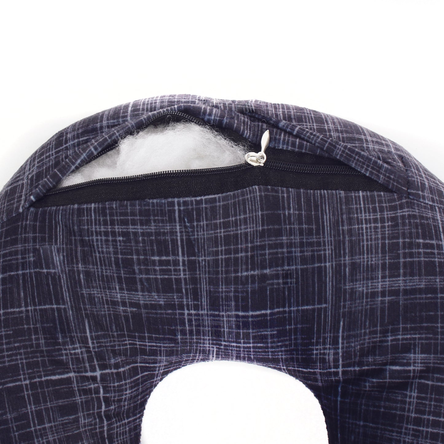 Close up view of the zipper opening on the Plush Travel Neck Pillow in Black Hatch, which is exposing the plush interior inside the pillow's cover.