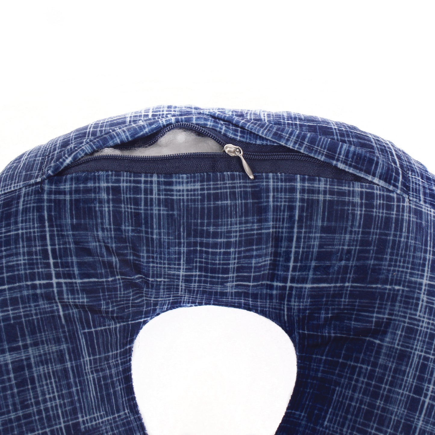 Close up view of the zipper opening on the Plush Travel Neck Pillow in Navy Hatch, which is exposing the plush interior inside the pillow's cover.