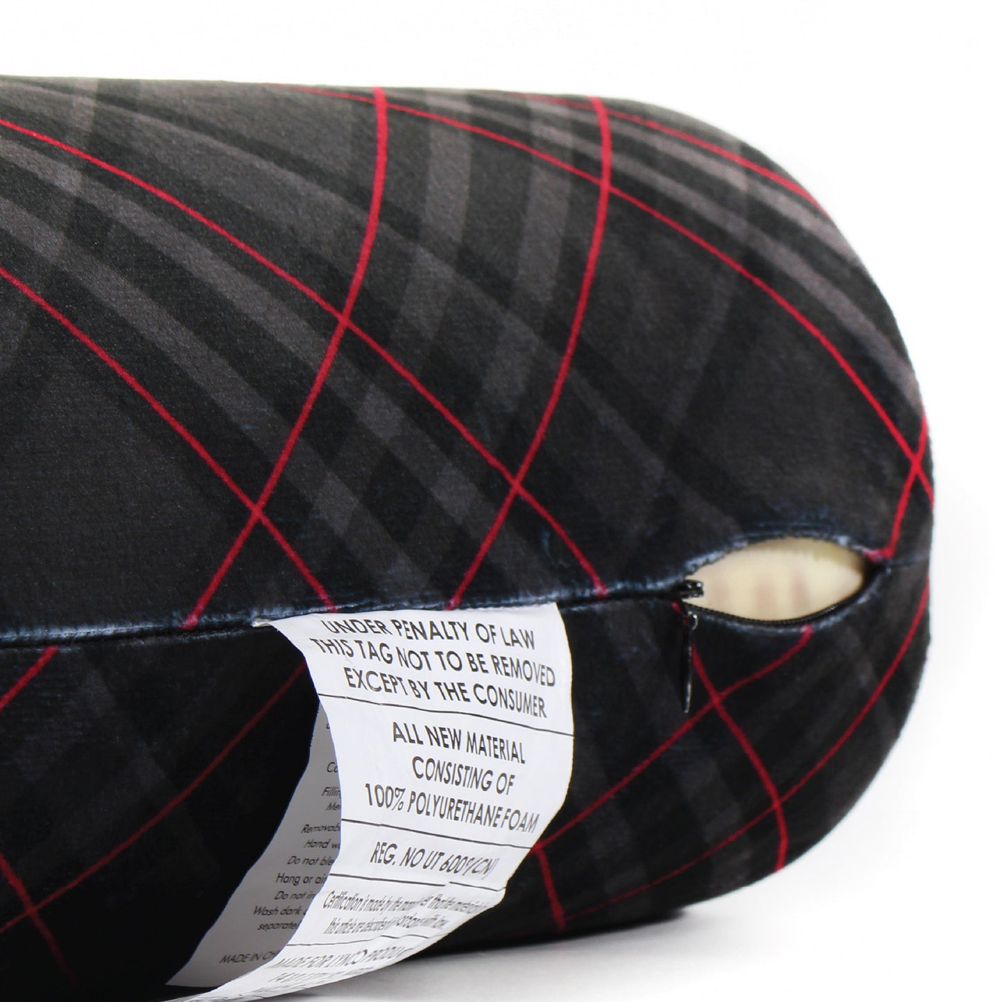 Close up view of the zipper opening on the Memory Foam Roll Travel Pillow in Black and Red Plaid, which is exposing the plush interior inside the pillow's cover.