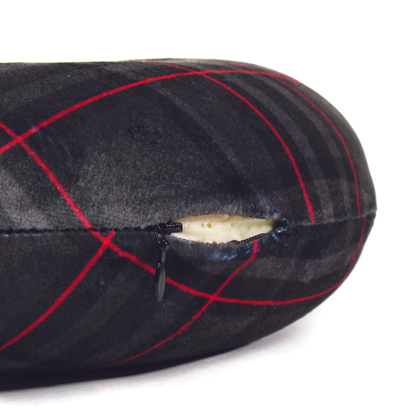 Close up view of the zipper opening on the Memory Foam Travel Neck Pillow in Black and Red Plaid, which is exposing the plush interior inside the pillow's cover.