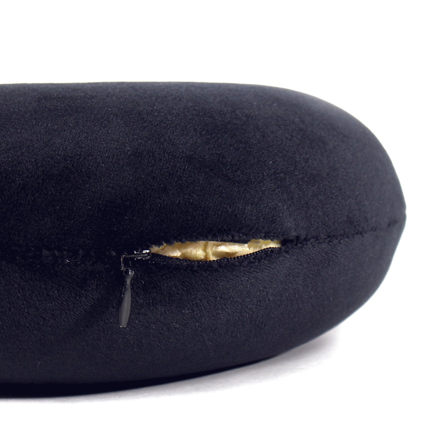 Close up view of the zipper opening on the Memory Foam Travel Neck Pillow in Black, which is exposing the plush interior inside the pillow's cover.