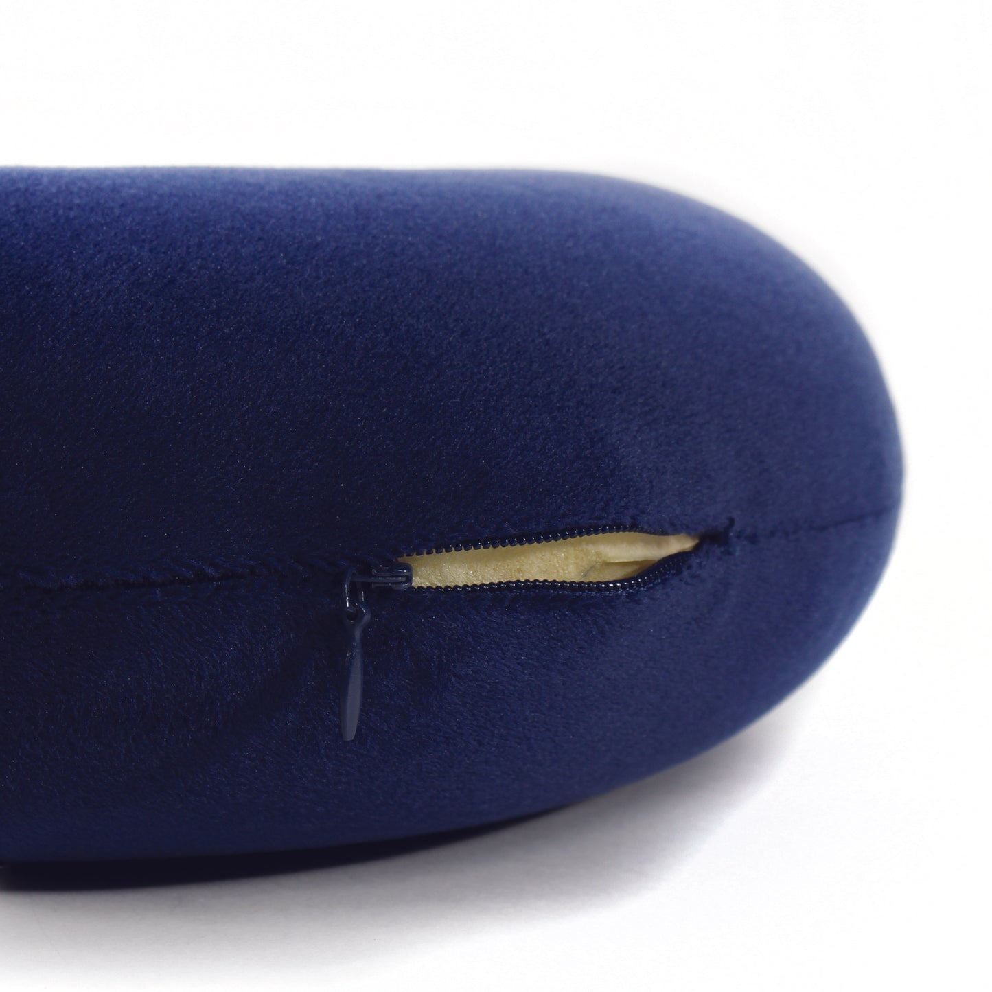 Close up view of the zipper opening on the Memory Foam Travel Neck Pillow in Navy, which is exposing the plush interior inside the pillow's cover.