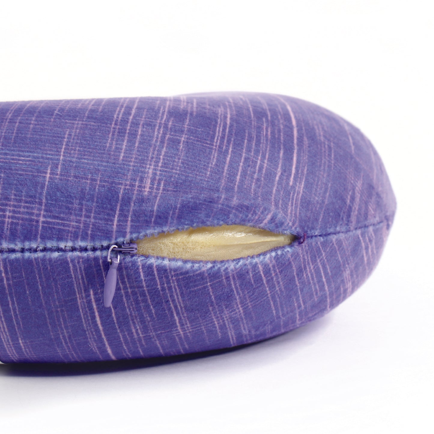 Close up view of the zipper opening on the Memory Foam Travel Neck Pillow in UV Hatch, which is exposing the plush interior inside the pillow's cover.
