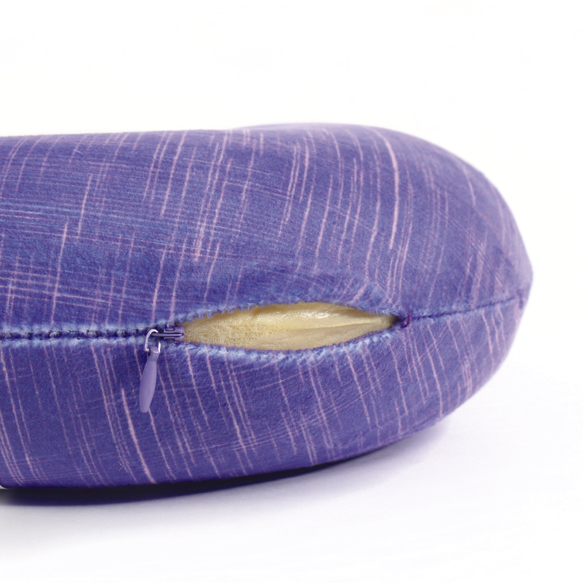 Close up view of the zipper opening on the Memory Foam Travel Neck Pillow in UV Hatch, which is exposing the plush interior inside the pillow's cover.