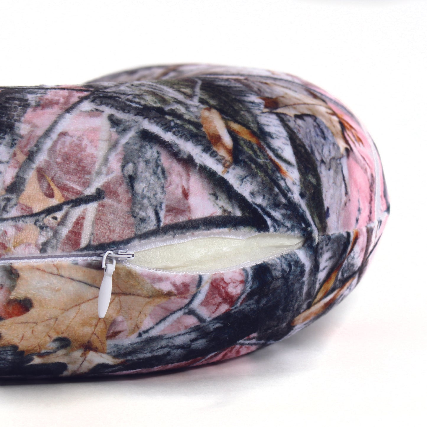Close up view of the zipper opening on the Memory Foam Travel Neck Pillow in Hunter's Stock Oneshot® Pink Camo, which is exposing the plush interior inside the pillow's cover.