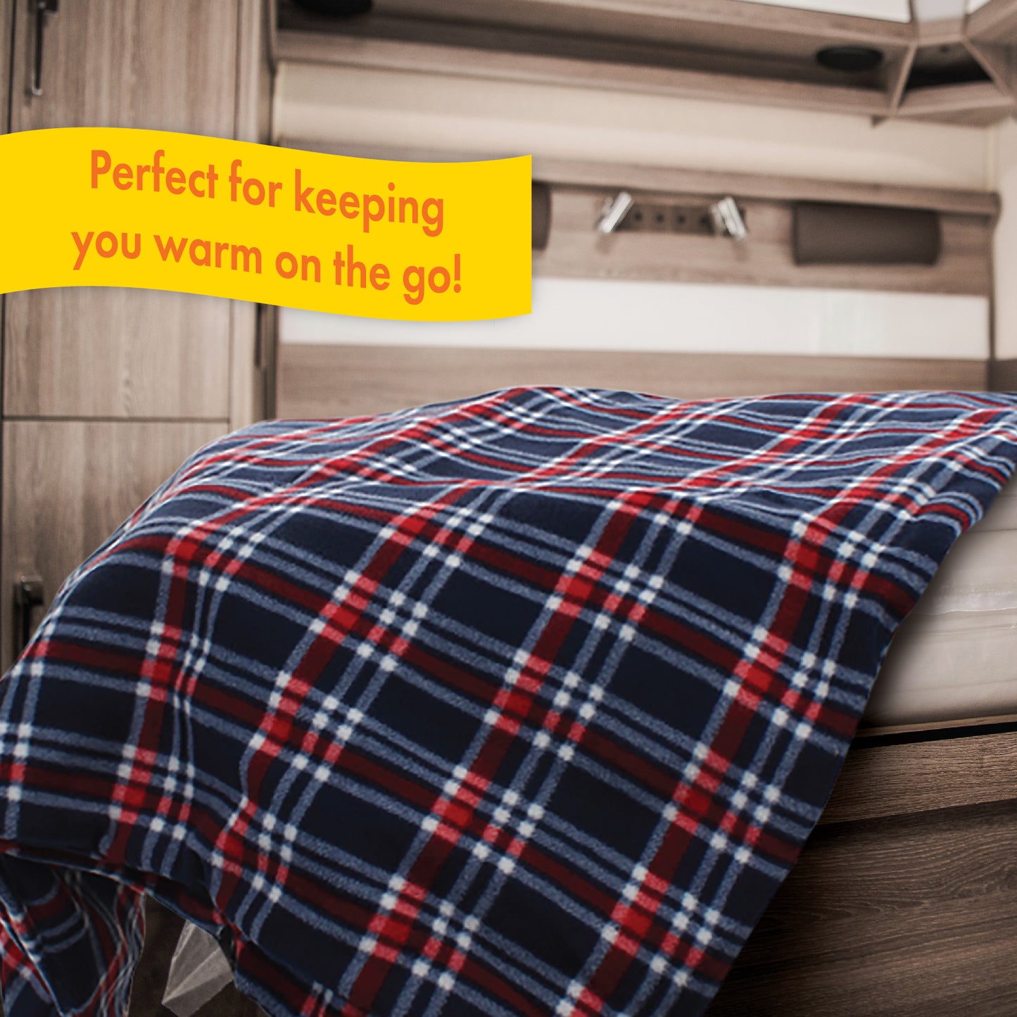 The 12V Fleece Heated Blanket spread out over a bed inside an RV camper, as this 12 volt heated blanket is perfect for keeping travelers warm on the go.