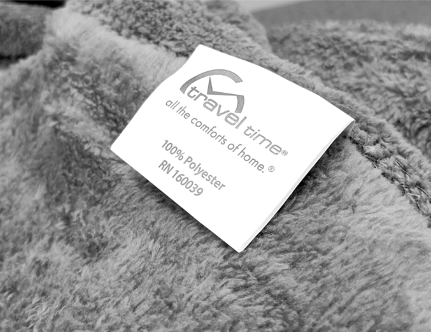 Close up shot of the tag attached to the Sherpa Teddy Throw Blanket in Gray