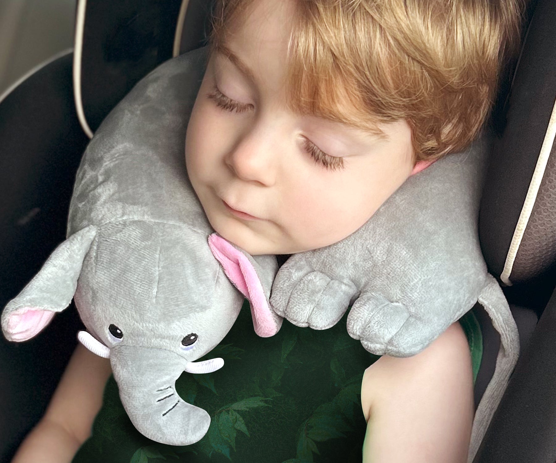 Youngster in his carseat wearing a Kids' Junior Elephant Travel Pillow