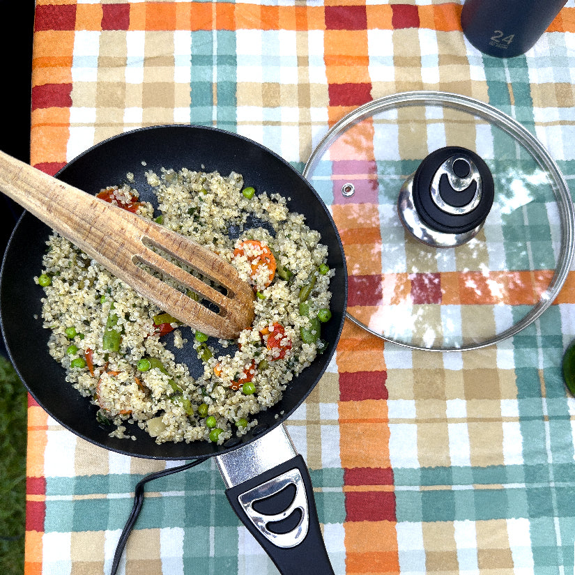 12 Volt Cooking Pan with Cover being used to prepare a warm cooked meal while on the go outside via the pan's 12 volt connector