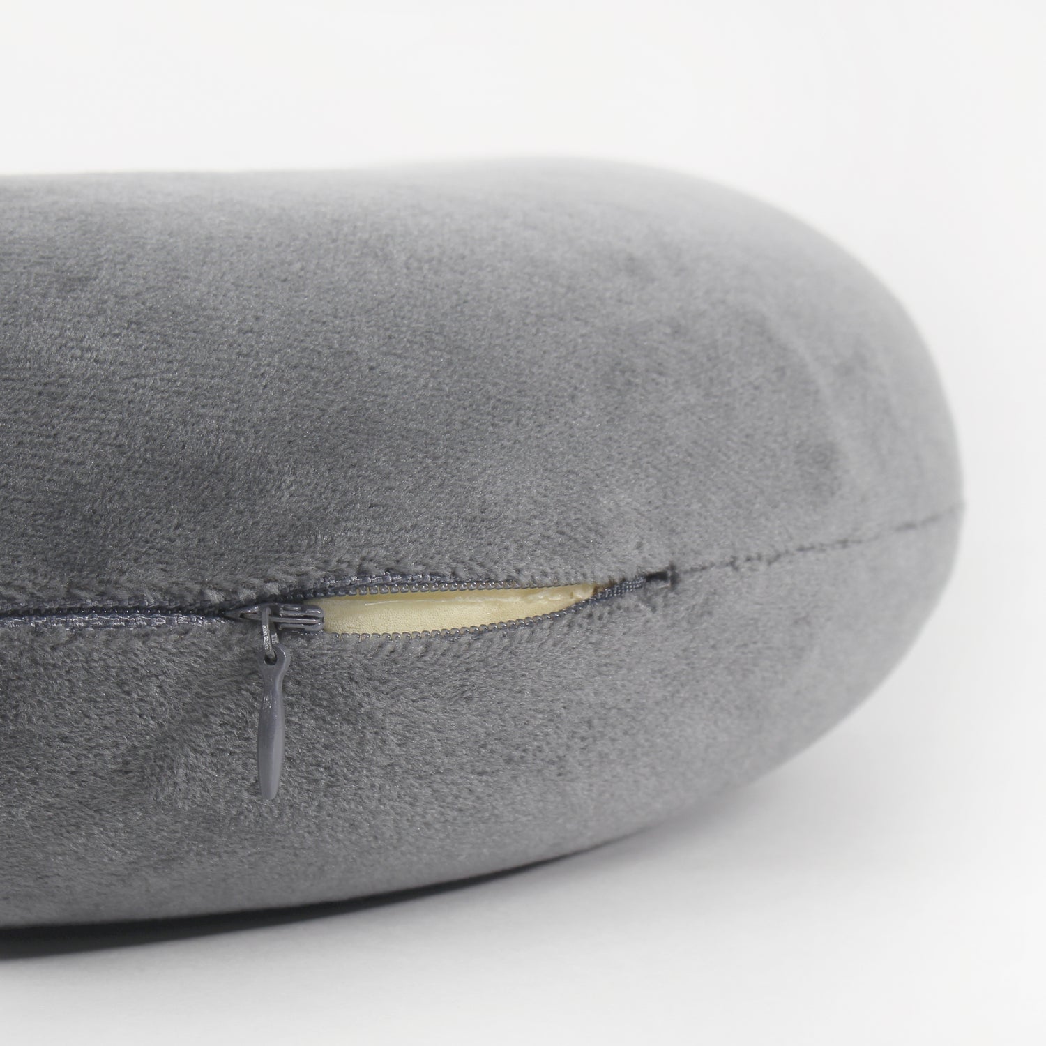 Close up angle of an opened zipper on the Memory Foam Travel Neck Pillow in Gray