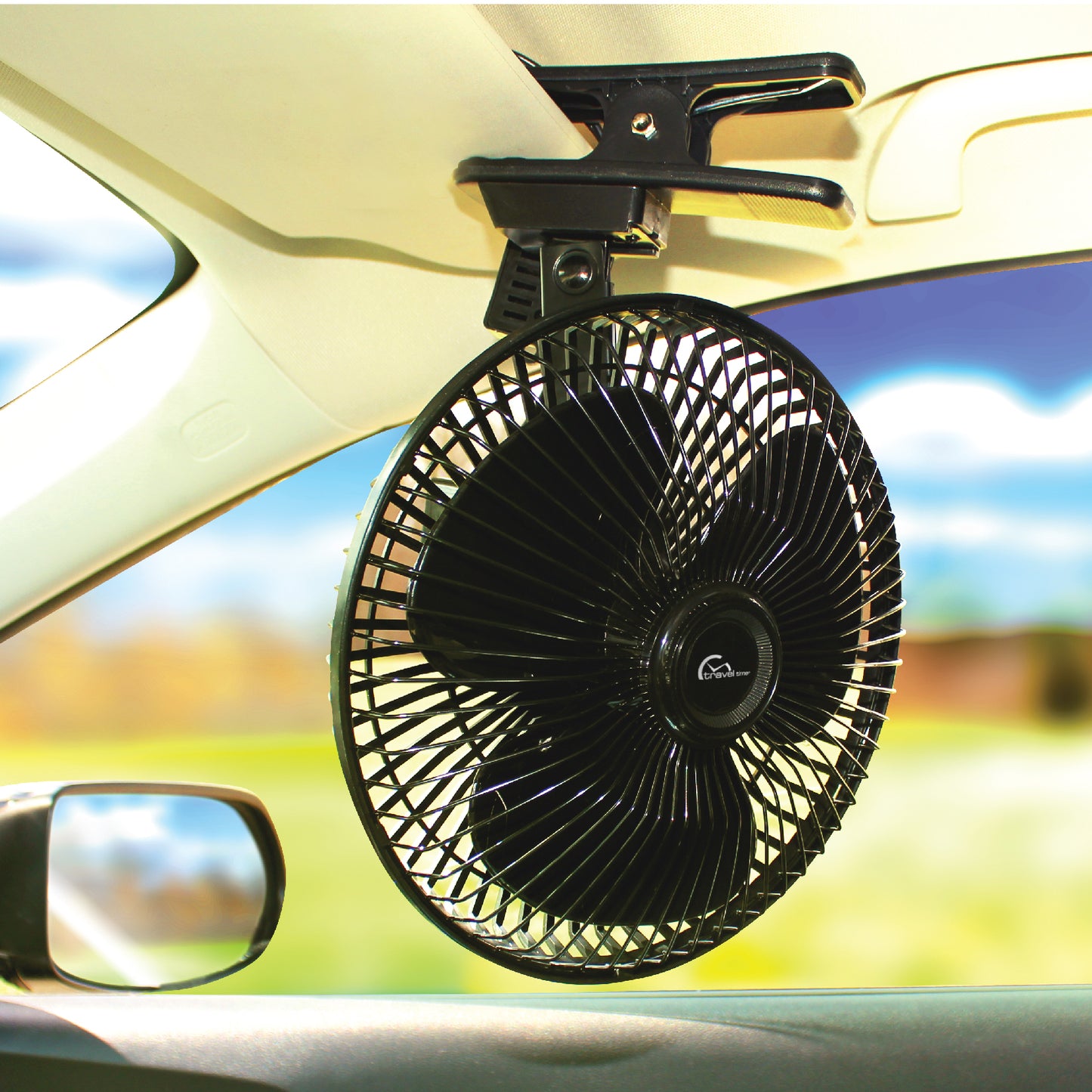 The 12V Oscillating Clip-On Fan has been clamped to the visor on the passenger side of a vehicle.